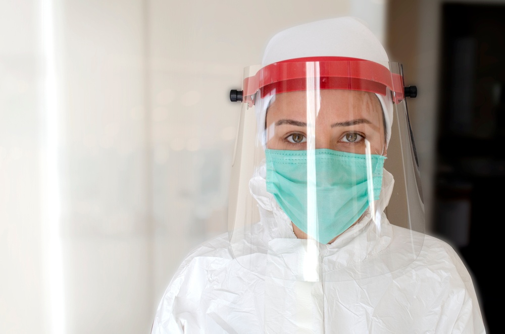 Medical personnel wearing PPE including safety goggles